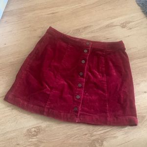 Wine red corduroy skirt with buttons down the middle. Great condition. Size (L)